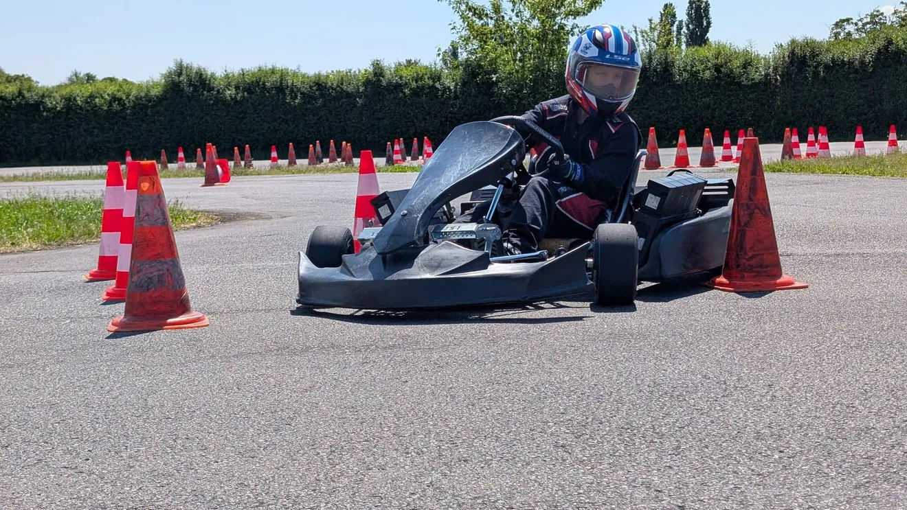 Kind im Kart zwischen roten Pylonen auf dem Vereinsplatz